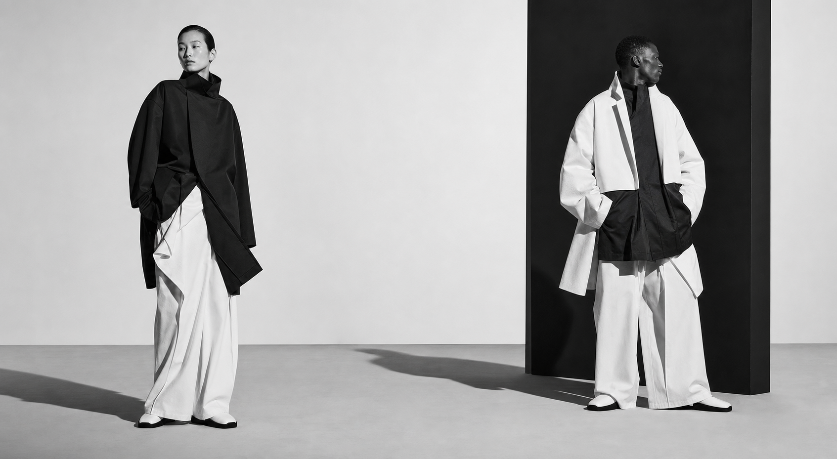 Two models in sculptural black-and-white Just Life tailoring
